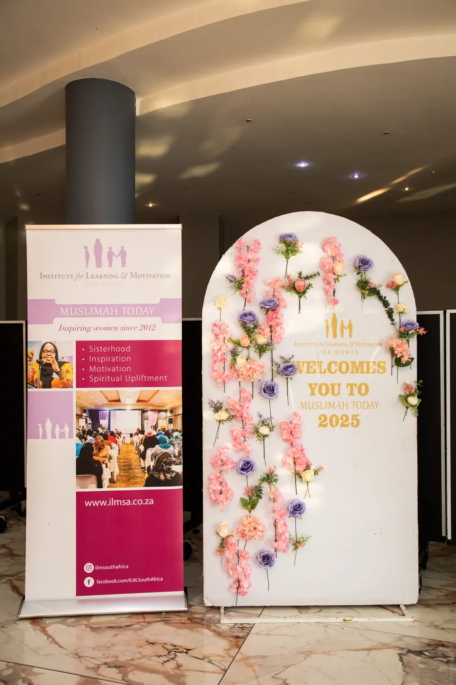 The floral “welcomes you” arch and ILM for Women banners at the entrance